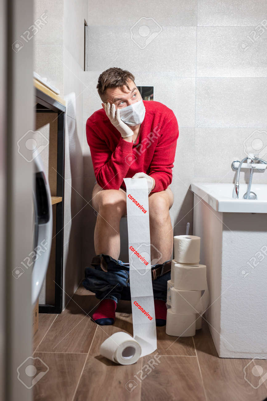 143518345-coronavirus-pandemic-man-on-the-toilet-a-man-in-a-medical-mask-and-a-red-sweater-in-the-toilet-holds.jpg
